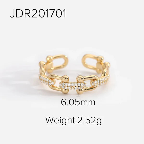 Orek Catena Lock Chain Ring ring on jewellery display, a U-shaped lock-and-chain detail lined w