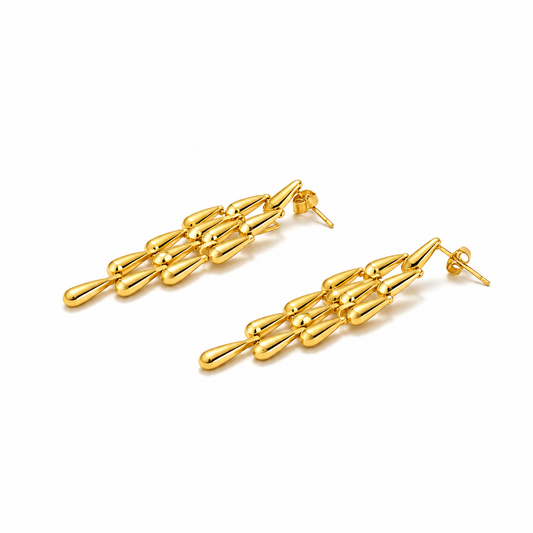 Close-up of Orek Woven Tassel Drop Earrings earrings detail, a long, woven tassel that sways with mov