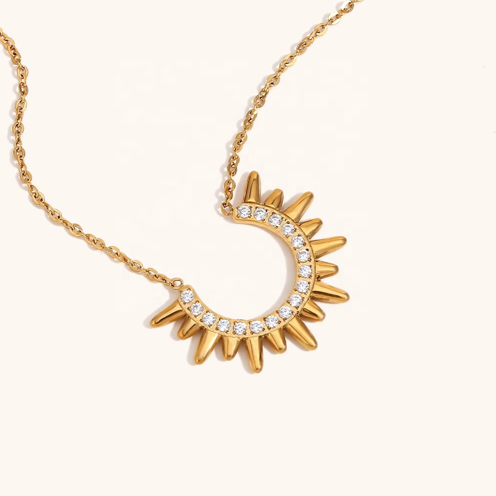 Orek Sunburst Charm Radiant Rise Necklace necklace on jewellery display, a radiant sunburst charm with fine sculp