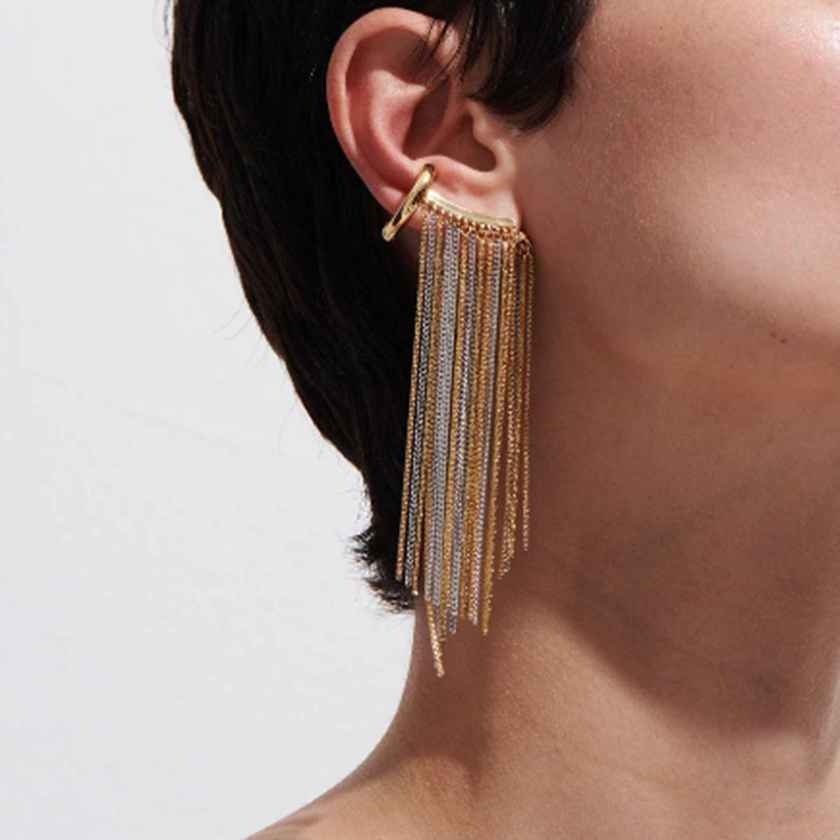 Close-up of Orek Arelia Mono Fringe Cuff earrings detail, a two-tone chain fringe worn as a single
