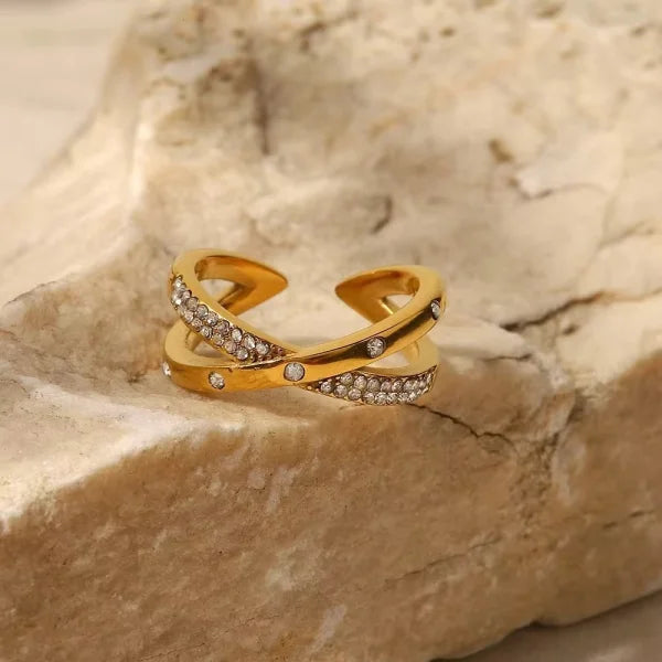 Close-up of Orek Crossina X Cross Ring ring detail, two layered bands crossing in an X, line