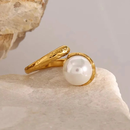 Close-up of Orek Perlina Hammered Pearl Ring Set ring detail, an irregular, hand-hammered wide band fi