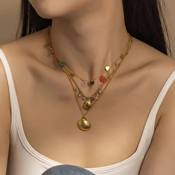 Close-up of Orek Ciela Ocean Charm Necklace necklace detail, a shell charm paired with green beads, i