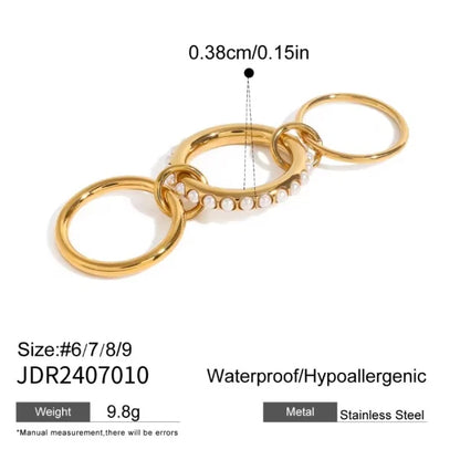 Orek Duetta Two-Finger Ring ring on jewellery display, a two-tone connector design that spans t