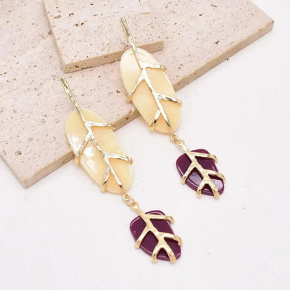 Woman wearing Orek Solene Boho Leaf Dangler earrings