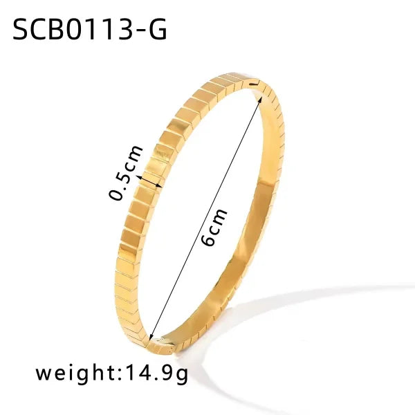 Orek Bold Radiance Square Edge Bangle bracelet on jewellery display, a textured surface set against sharp, sq