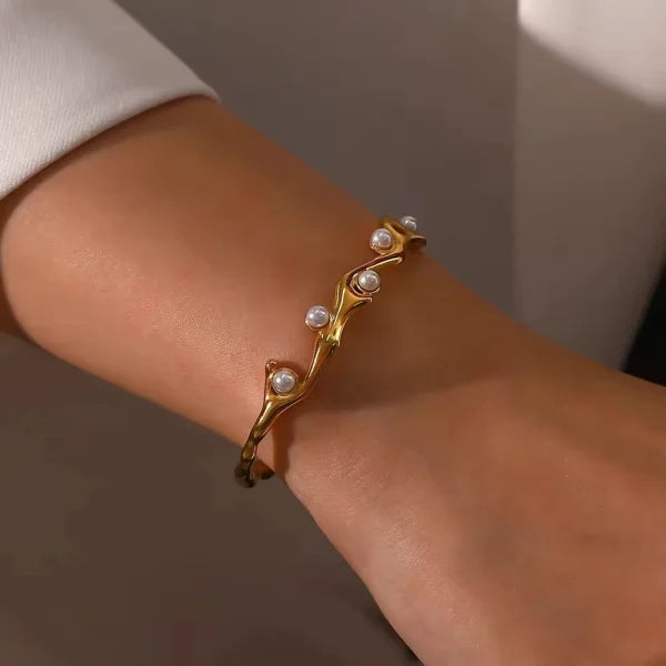 Close-up of Orek Terra Stone Pearl Bangle bracelet detail, an irregular open cuff set with a natura