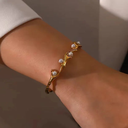 Close-up of Orek Terra Stone Pearl Bangle bracelet detail, an irregular open cuff set with a natura