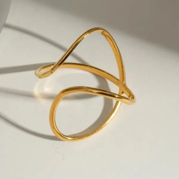 Close-up of Orek Nova Crossover Ring ring detail, two polished bands crossing over each ot