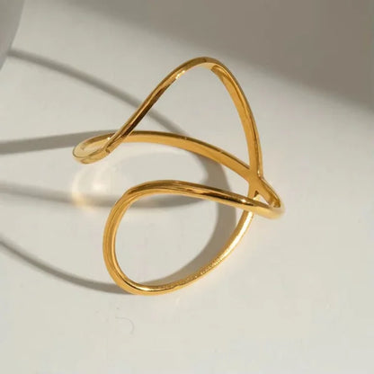 Close-up of Orek Nova Crossover Ring ring detail, two polished bands crossing over each ot
