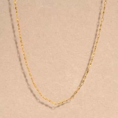 Close-up of Orek Kova Infinite Loop Necklace, showing anti-tarnish gold plated finish