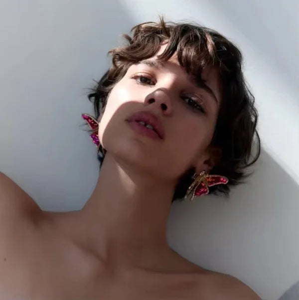 Woman wearing Orek Noira Scarlet Flutter Earring earrings