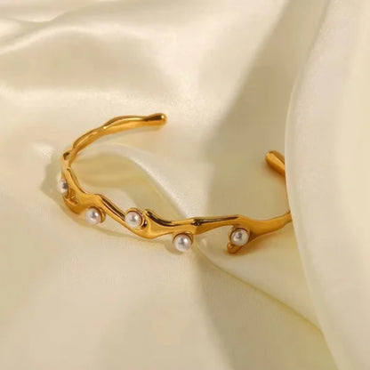 Woman wearing Orek Terra Stone Pearl Bangle bracelet