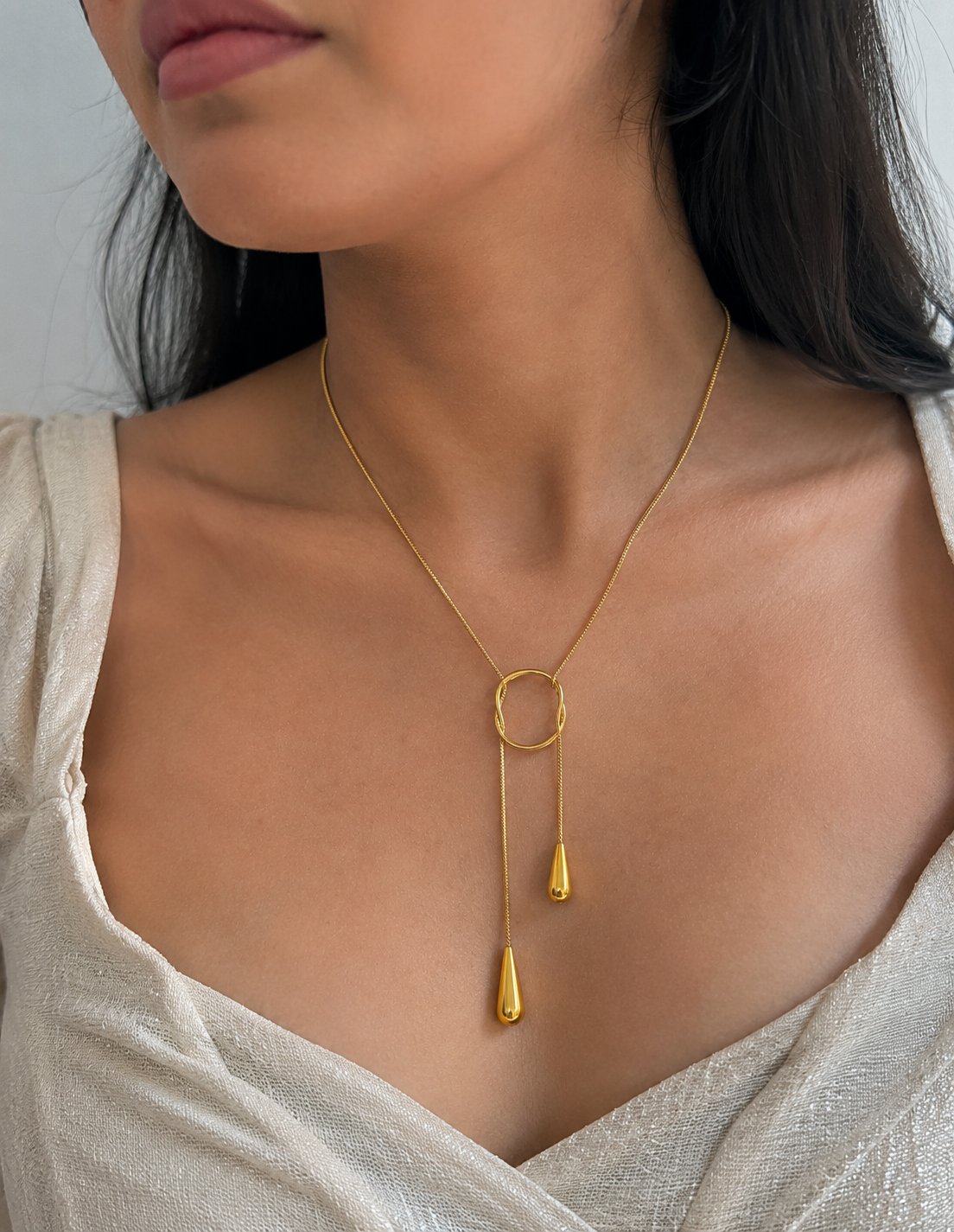 Close-up of Orek Evara Loop Drop Necklace necklace detail, an adjustable lariat-style chain that lo