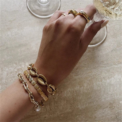 Orek Sora Luxe Adjustable Bangle bracelet on jewellery display, a shell-shaped curve with a smooth, scul