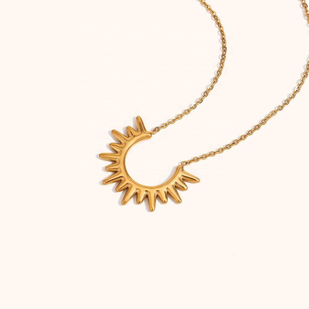 Close-up of Orek Sunburst Charm Radiant Rise Necklace necklace detail, a radiant sunburst charm with fine sculp