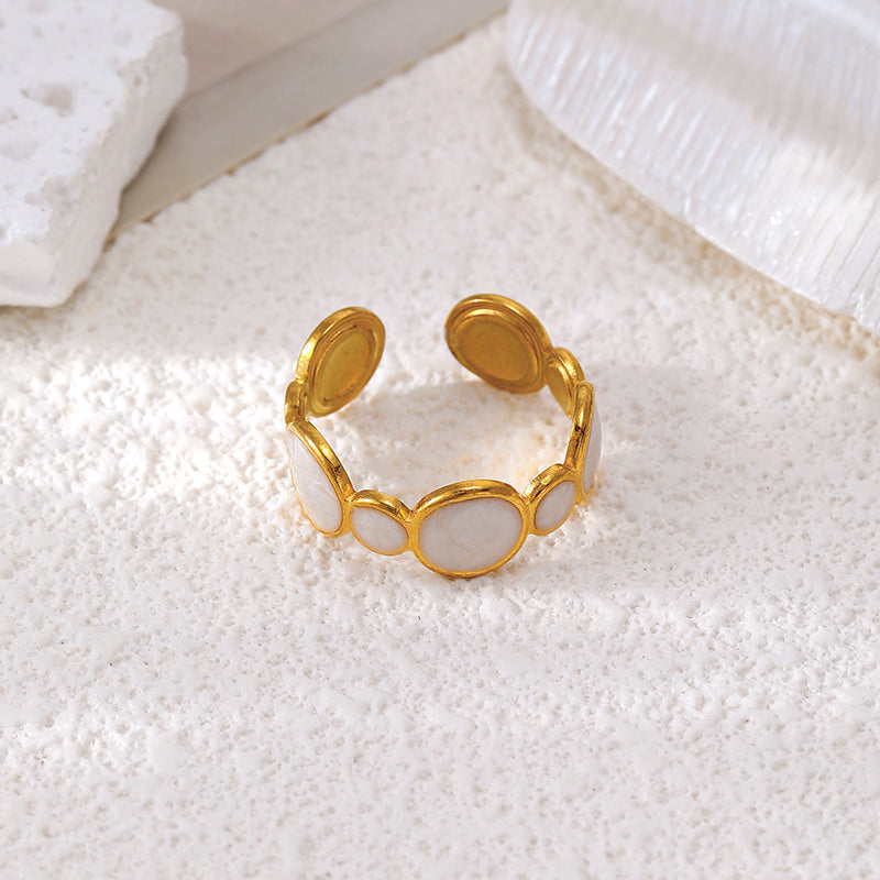 Orek Strata Wide Band Ring ring on jewellery display, a wide, geometric band with clean, layer