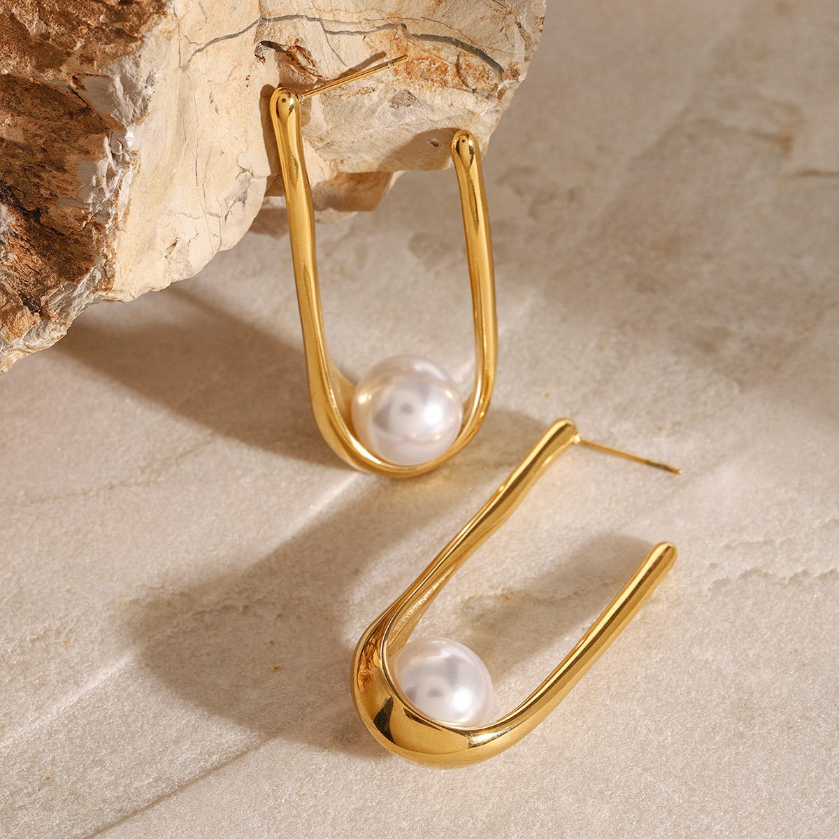 Woman wearing Orek Era U Shell Pearl Earrings earrings