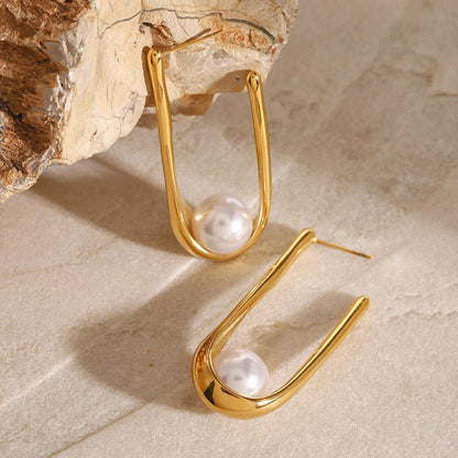 Woman wearing Orek Era U Shell Pearl Earrings earrings