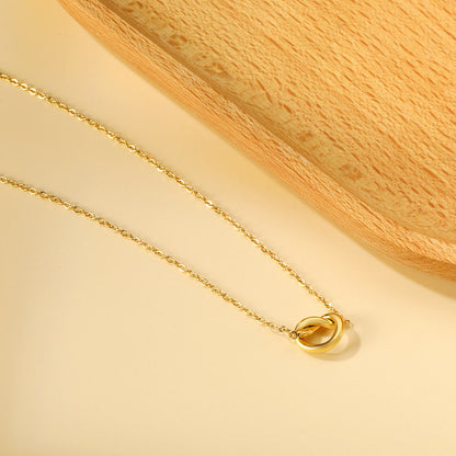 Close-up of Orek Heart Love Knot Necklace necklace detail, an interlocking heart and love-knot pend