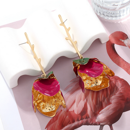 Woman wearing Orek Solene Metallic Rose Dangler earrings