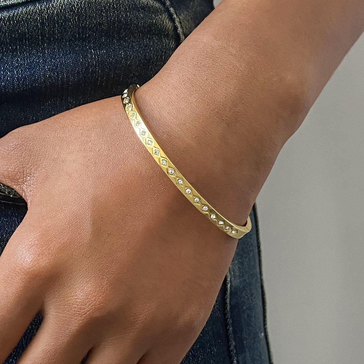 Woman wearing Orek Elyra Sparkle Clasp Bangle bracelet