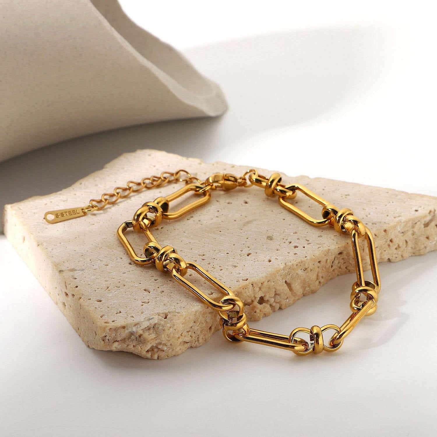 Orek Flat Paperclip Bracelet bracelet on jewellery display, chunky, flat rectangle links in a paperc
