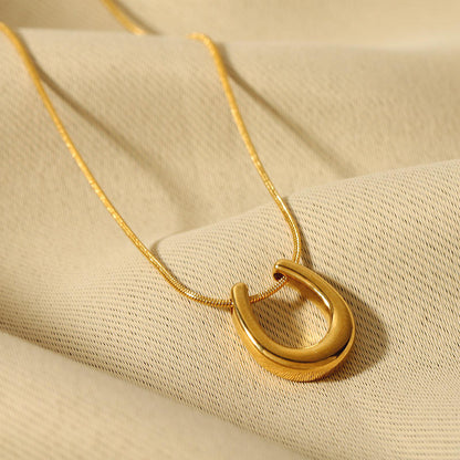 Close-up of Orek Evara Lunar Sweep Necklace necklace detail, a minimalist crescent-moon curve pendant