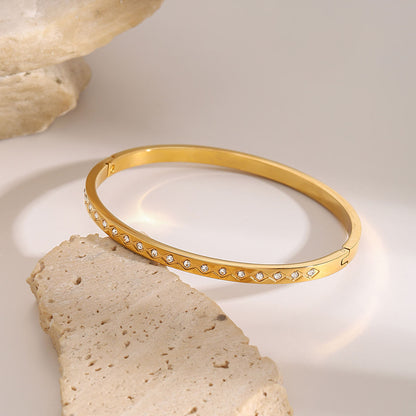 Close-up of Orek Elyra Sparkle Clasp Bangle bracelet detail, a sparkling row of round cubic zirconia 