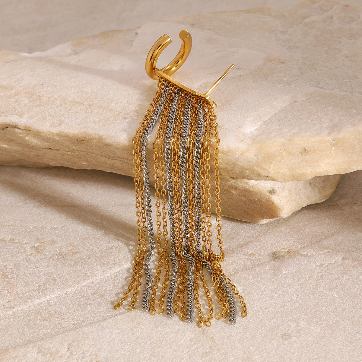 Orek Arelia Mono Fringe Cuff earrings on jewellery display, a two-tone chain fringe worn as a single
