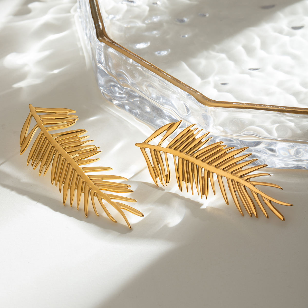 Orek Harmony Leaf Pair Earrings earrings on jewellery display, a pair of European-inspired leaf silhoue