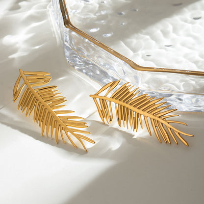 Orek Harmony Leaf Pair Earrings earrings on jewellery display, a pair of European-inspired leaf silhoue