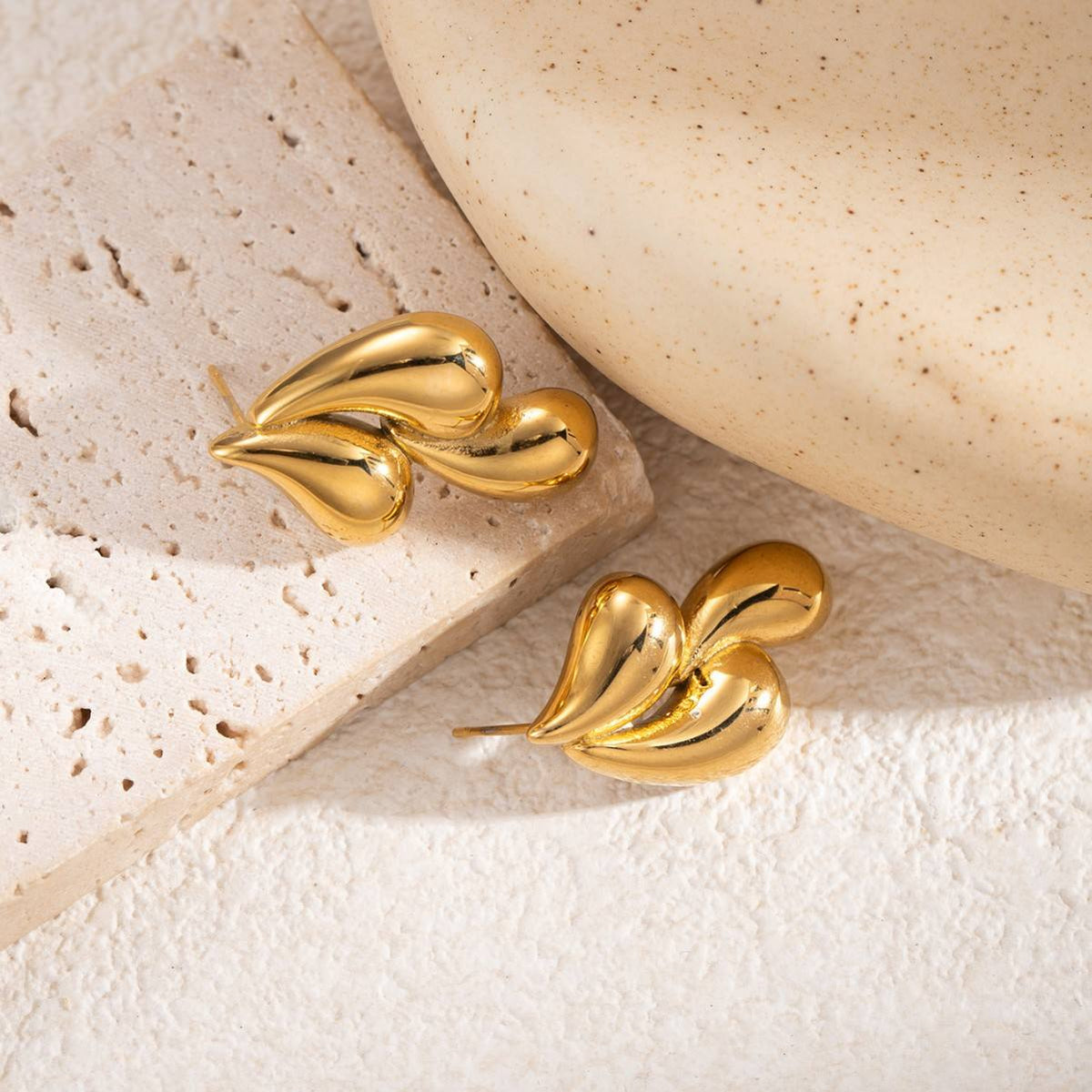 Woman wearing Orek Golden Swirl Drop Earrings earrings
