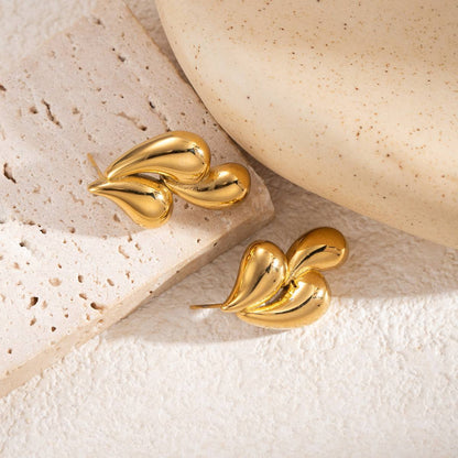 Woman wearing Orek Golden Swirl Drop Earrings earrings