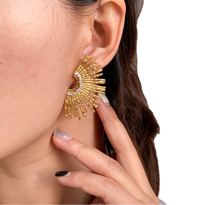 Close-up of Orek Ivra Golden Petal Earring earrings detail, a scalloped sunflower silhouette lined w