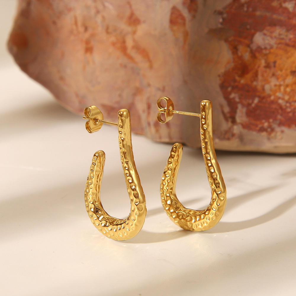 Close-up of Orek Kira Hammered U Earrings Deluxe earrings detail, a fuller, U-shaped silhouette with a dee
