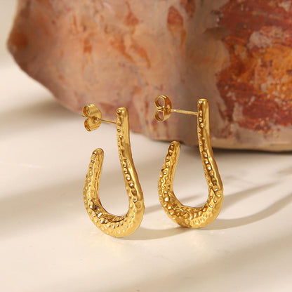 Close-up of Orek Kira Hammered U Earrings Deluxe earrings detail, a fuller, U-shaped silhouette with a dee