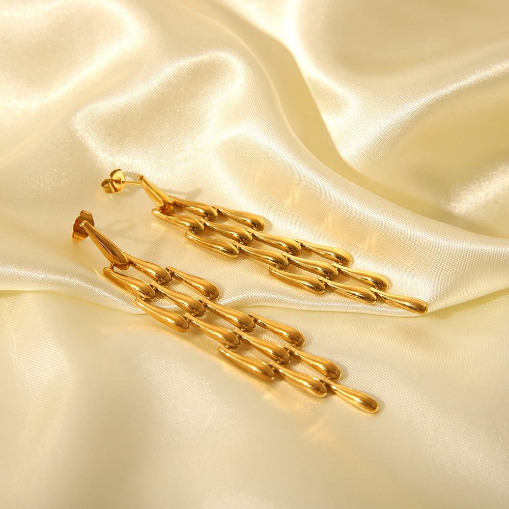 Orek Woven Tassel Drop Earrings earrings on jewellery display, a long, woven tassel that sways with mov