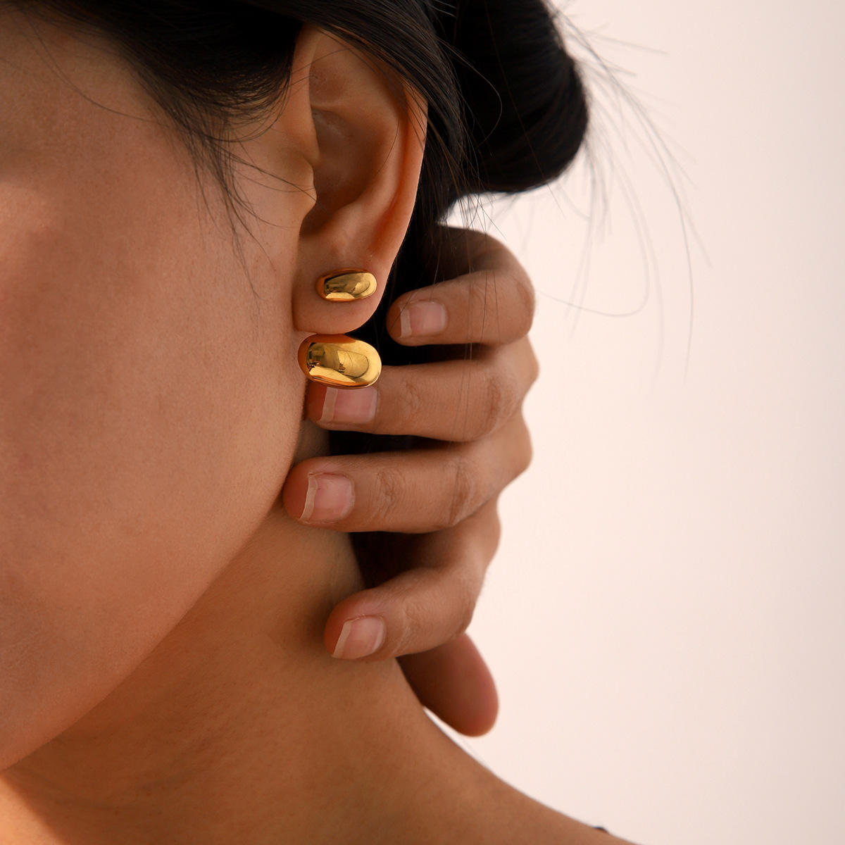 Close-up of Orek Evra Smooth Glassy Vintage Studs earrings detail, a slightly larger, high-polish glass-lik