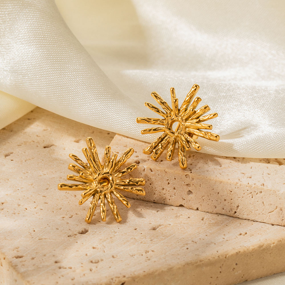 Woman wearing Orek Evara Burning Sun Studs earrings