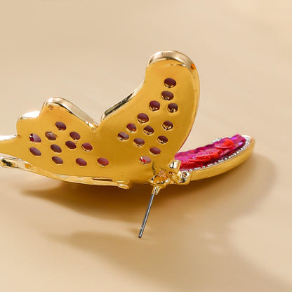 Orek Noira Scarlet Flutter Earring earrings on jewellery display, a red sequin butterfly with delicate, fl