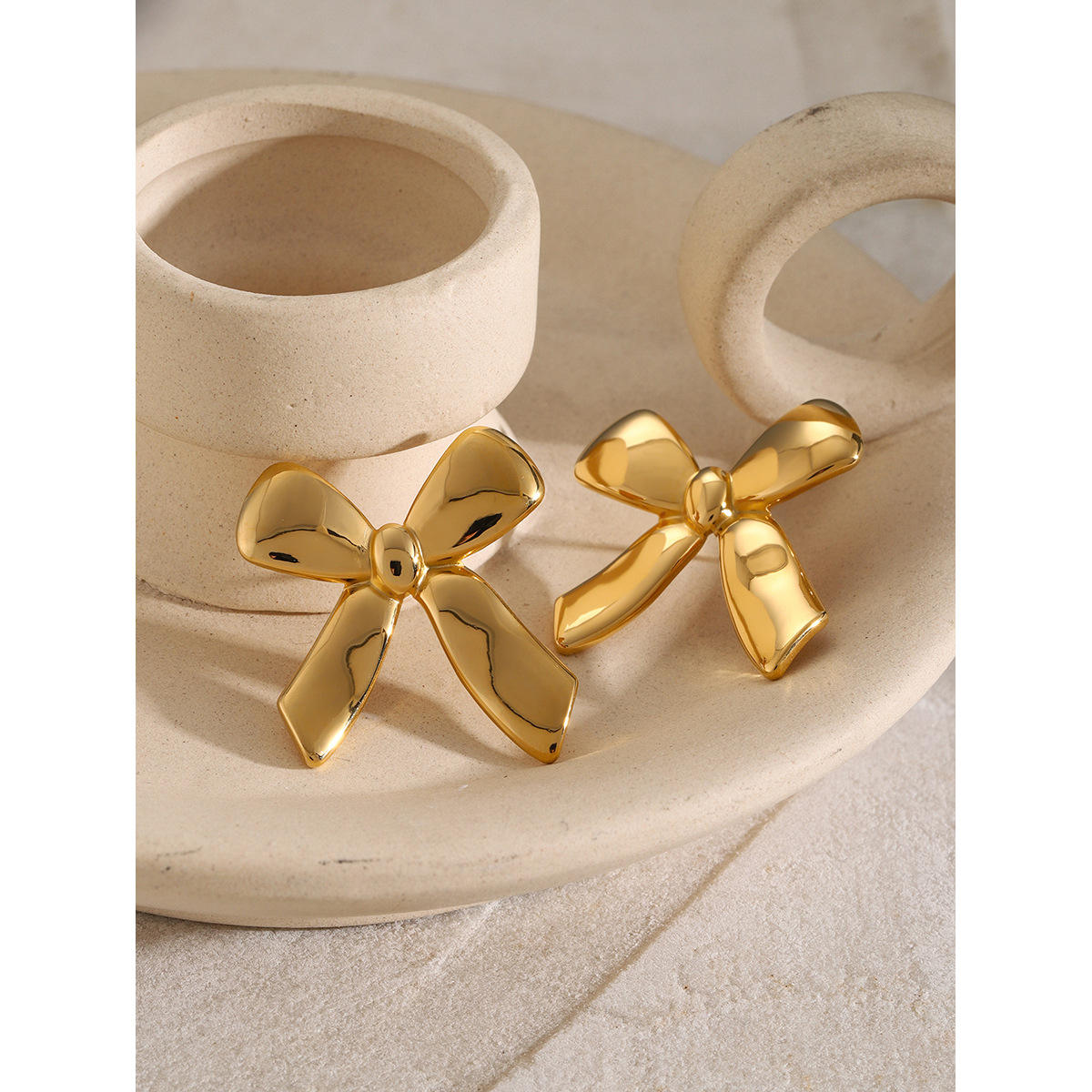 Woman wearing Orek Charming Bow Stud earrings