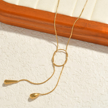 Orek Evara Loop Drop Necklace necklace on jewellery display, an adjustable lariat-style chain that lo