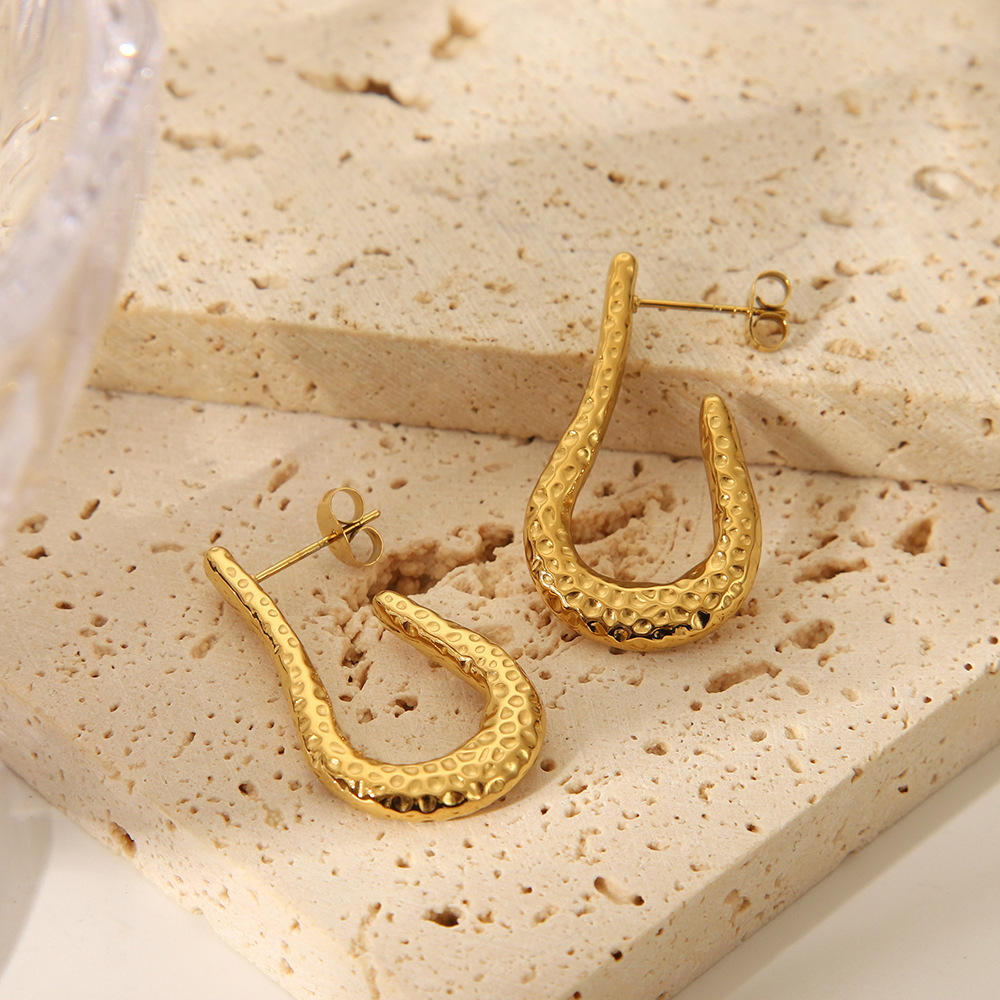 Woman wearing Orek Kira Hammered U Earrings Deluxe earrings