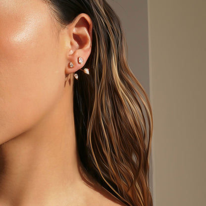 Close-up of Orek Era Pear Crystal Studs earrings detail, a pear-cut crystal set in a removable, c