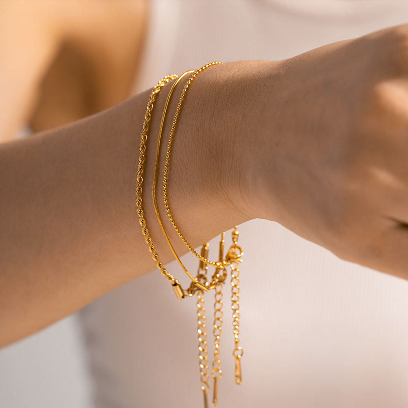 Close-up of Orek Trio Beaded Stack Bracelet bracelet detail, three thin, twisted chains layered with 