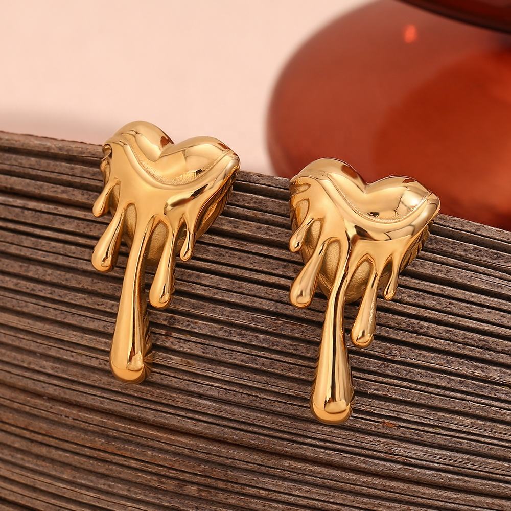 Orek Noira Molten Heart Earring earrings on jewellery display, an irregular, lava-textured heart silhou