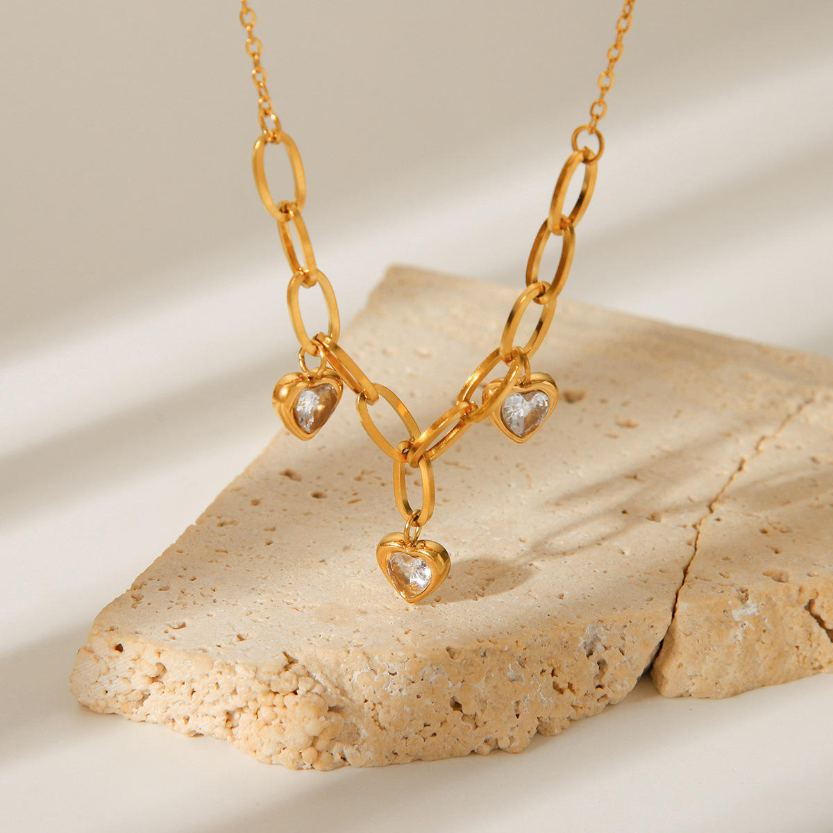 Orek Evara Heart Link Necklace necklace on jewellery display, a heart charm set with sparkling cubic z