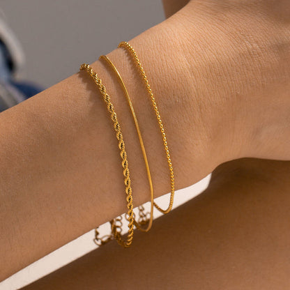 Orek Trio Beaded Stack Bracelet bracelet on jewellery display, three thin, twisted chains layered with 