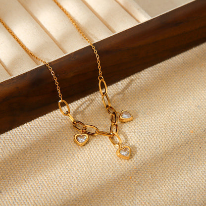 Close-up of Orek Evara Heart Link Necklace necklace detail, a heart charm set with sparkling cubic z